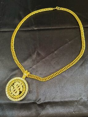 Gold tone chain revolving dollar logo necklace